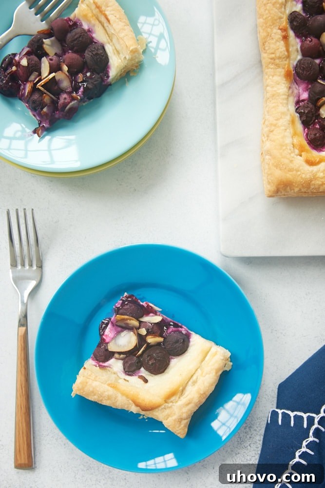 slices of Blueberry Cream Cheese Tart on blue plates