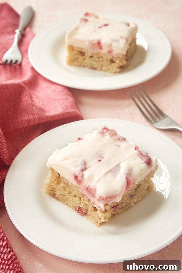 slices of Strawberry Sheet Cake on white plates