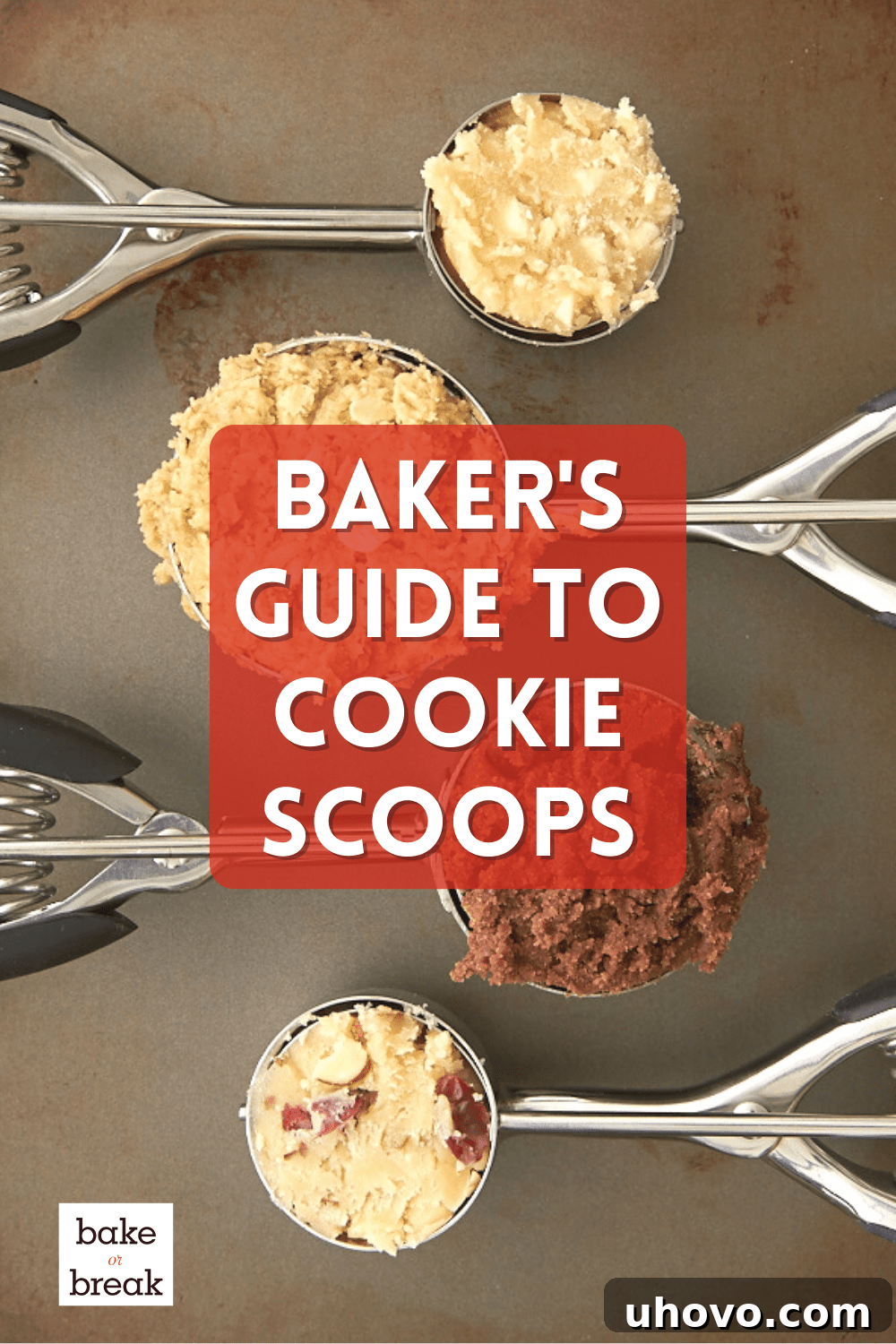 A vibrant collection of stainless steel cookie scoops in various sizes, neatly arranged on a pristine baking surface, ready for use.
