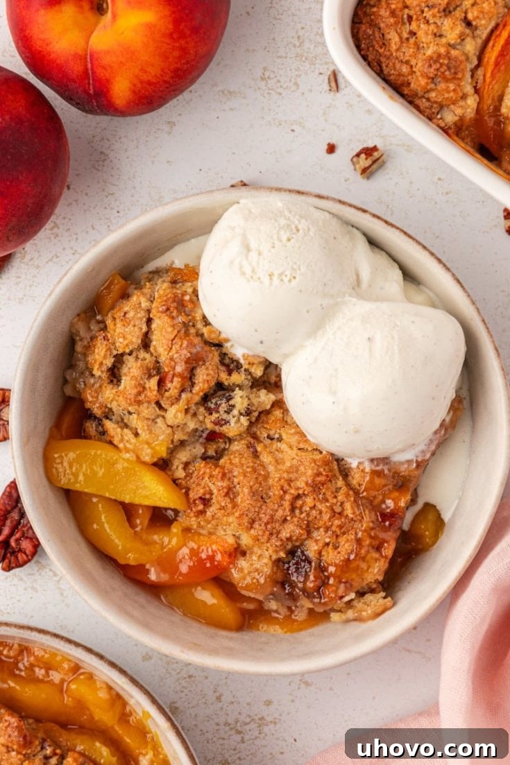 Ginger Pecan Peach Cobbler with a scoop of vanilla ice cream