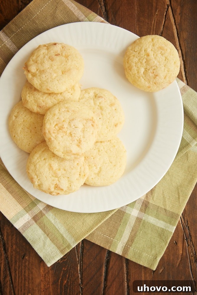 Plate of bright lemon coconut sugar cookies, garnished with coarse sugar.