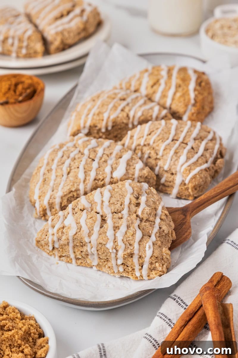 Soft, lightly sweet Cinnamon Oat Scones served on a white plate, highlighting their cozy cinnamon flavor and hearty texture.