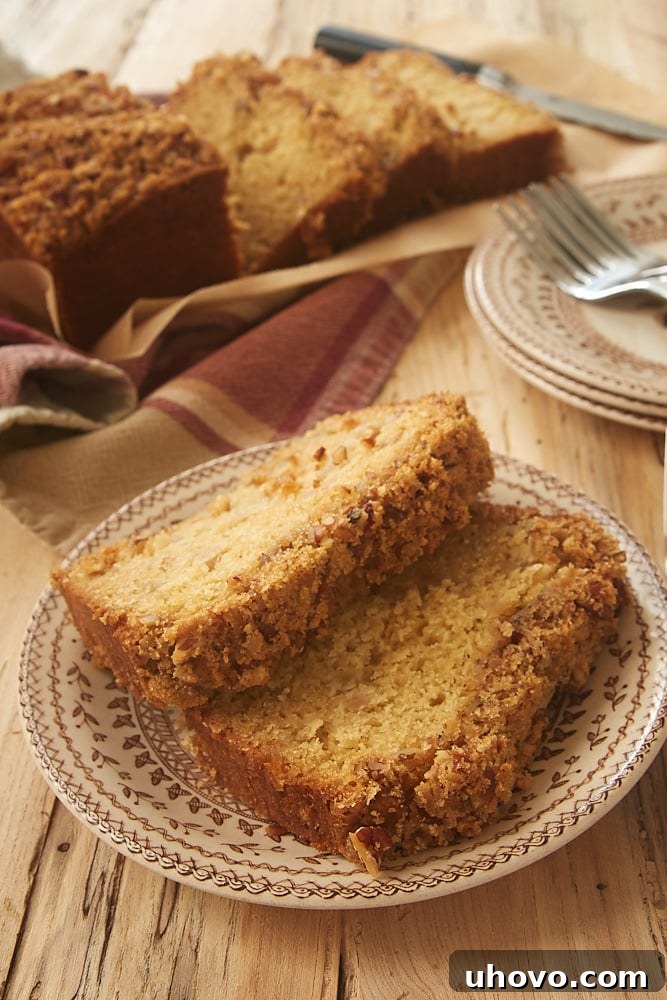 Slices of moist Ginger Pear Bread with a crunchy pecan topping
