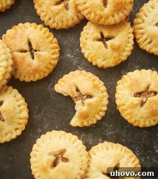 Pecan Hand Pies on a dark surface, highlighting their golden brown crusts.