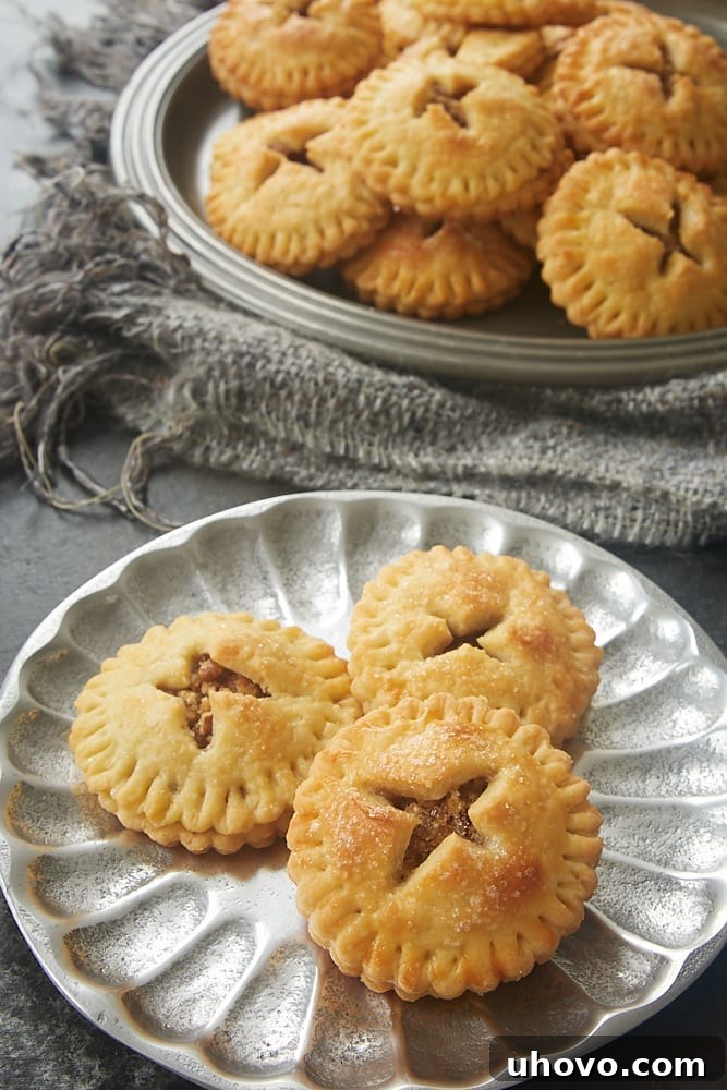 Close-up of Pecan Hand Pies served on a rustic pewter plate.