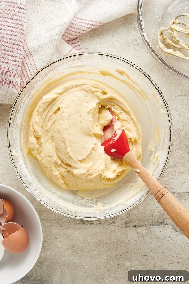overhead view of mixed dough for Cream Cheese Thumbprint Cookies in a glass mixing bowl