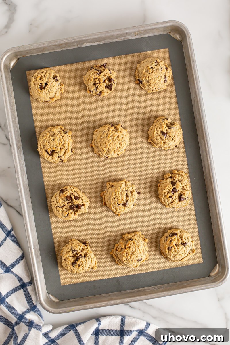 Overhead view of Oatmeal Peanut Butter Chocolate Chip Cookies on silpat-lined baking sheet