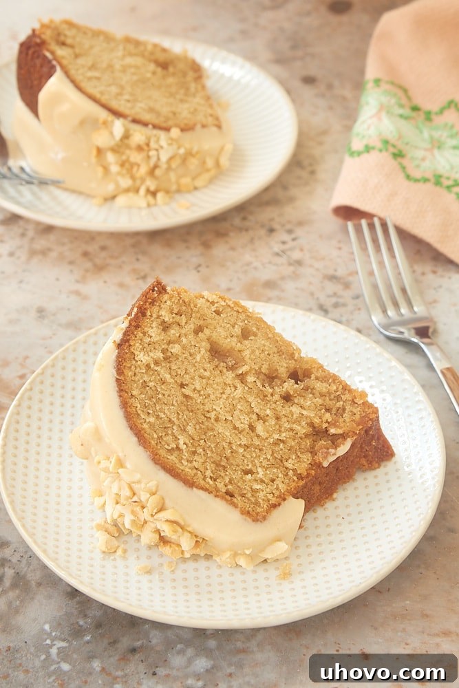 A perfect slice of Peanut Butter Bundt Cake, showcasing its moist texture and generous glaze.