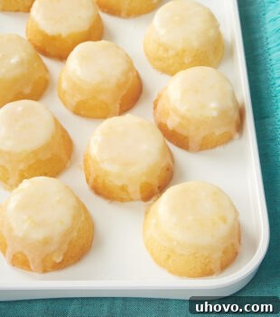 a white tray of Mini Lemon Pound Cakes with a vibrant lemon glaze, ready to be served
