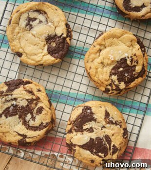 Jacques Torres Chocolate Chip Cookies on a wire cooling rack, highlighting their perfect texture and rich chocolate.