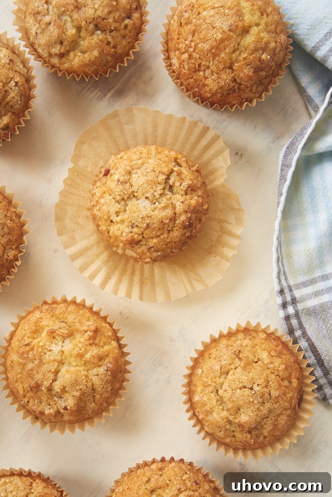 Several Brown Butter Coconut Pecan Muffins on a light surface, ready to be enjoyed as a delightful treat