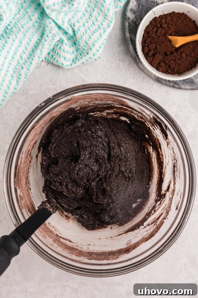 overhead view of mixed brownie batter in a bowl