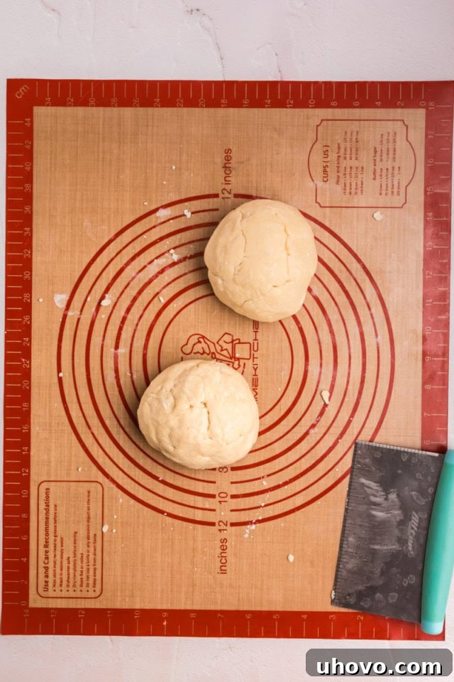 overhead view of cream cheese pastry dough on a silicone rolling mat