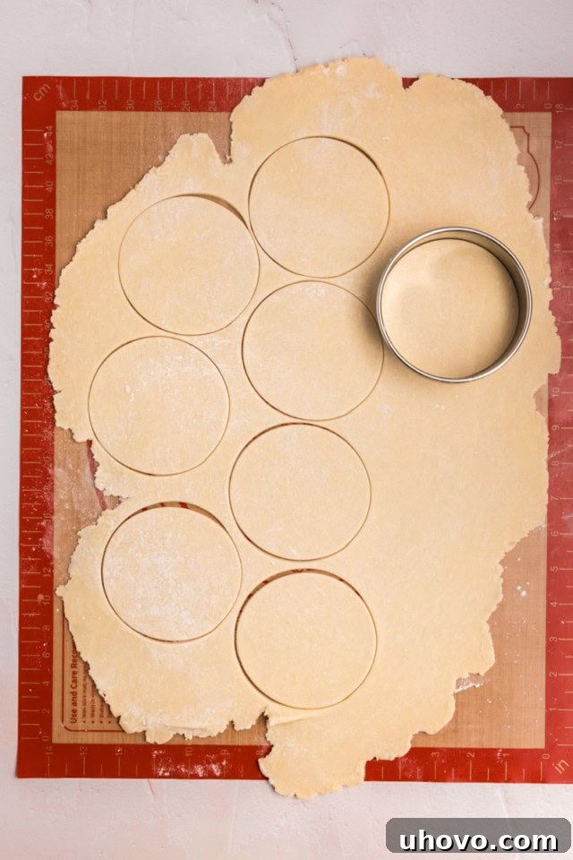 overhead view of rolled cream cheese pastry dough being cut into rounds