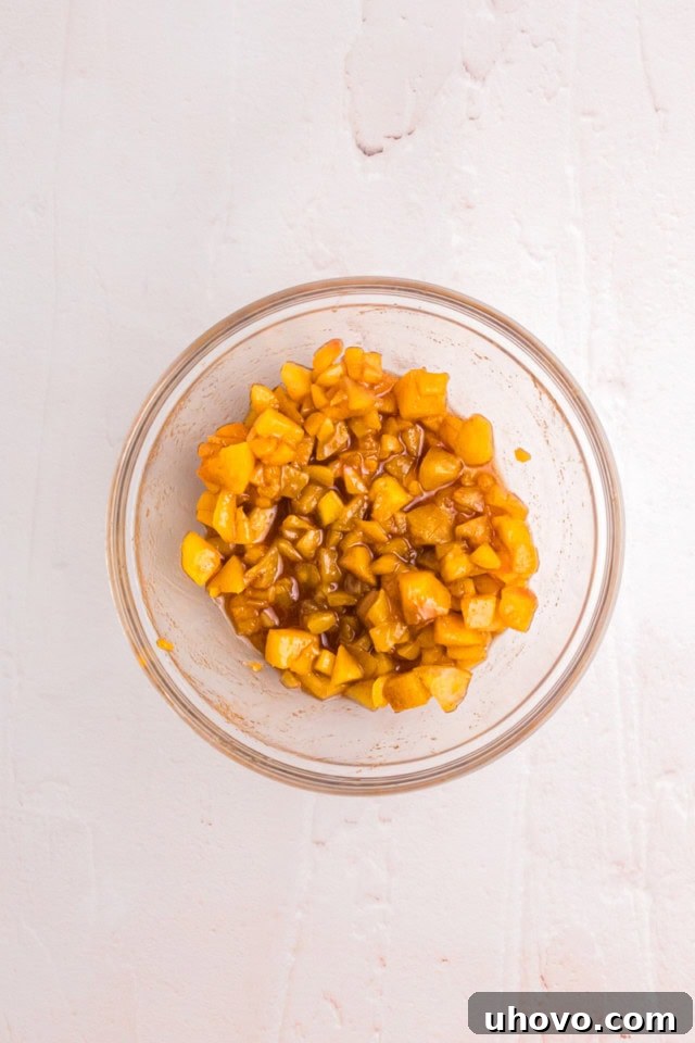 overhead view of mixed filling for peach hand pies in a glass bowl