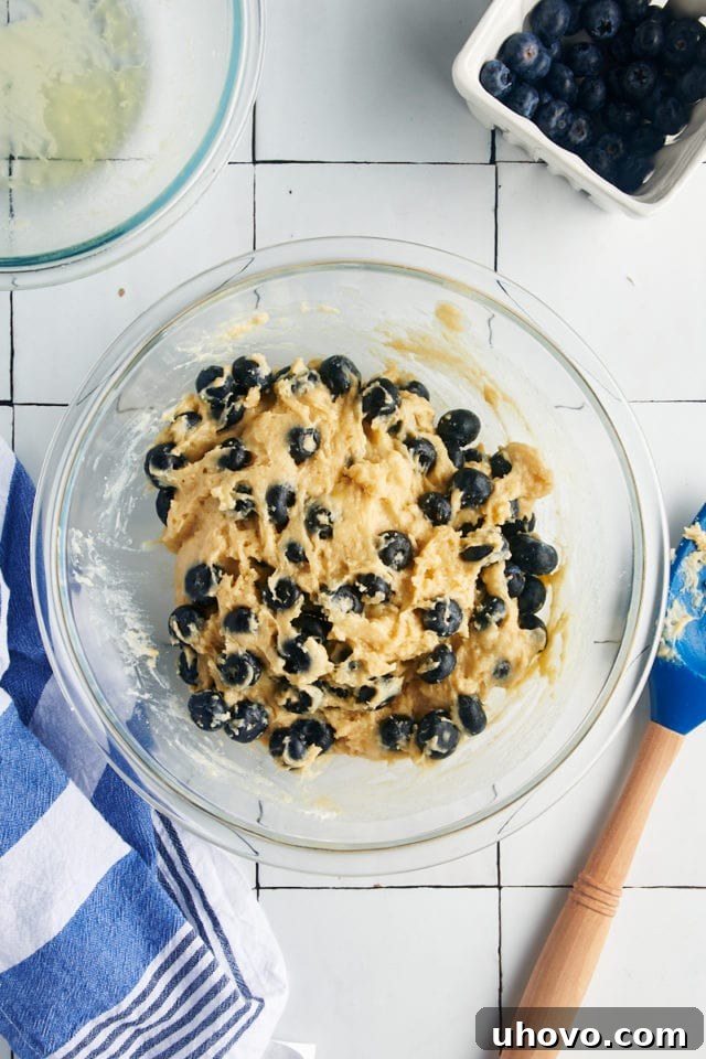 Fresh blueberries mixed into batter.