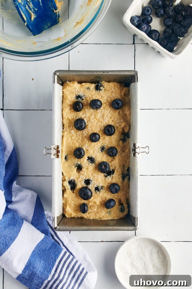 Blueberry bread batter poured into a loaf pan.