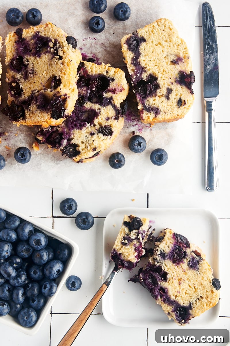 Blueberry loaf next to a bunch of fresh blueberries.