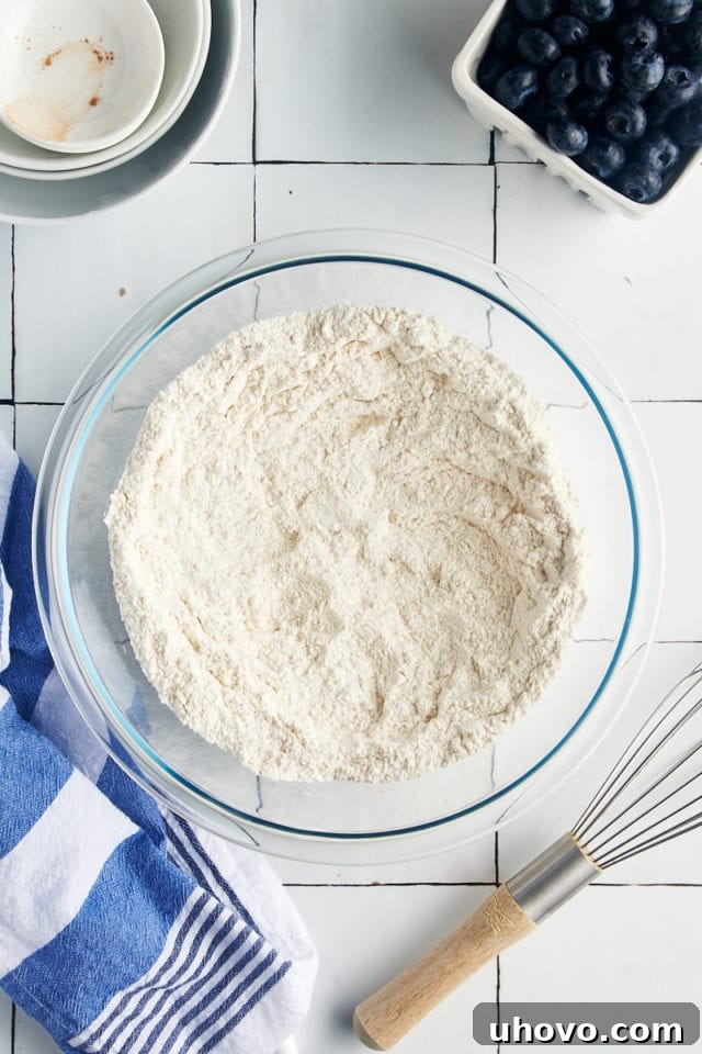 Dry ingredients made into a well in a mixing bowl.