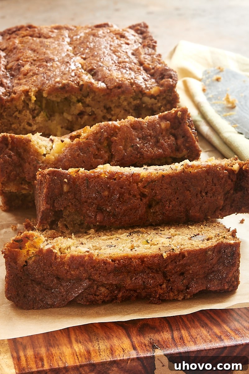 Multiple stacked slices of Pineapple Zucchini Bread, inviting and showcasing the beautiful texture of the quick bread.