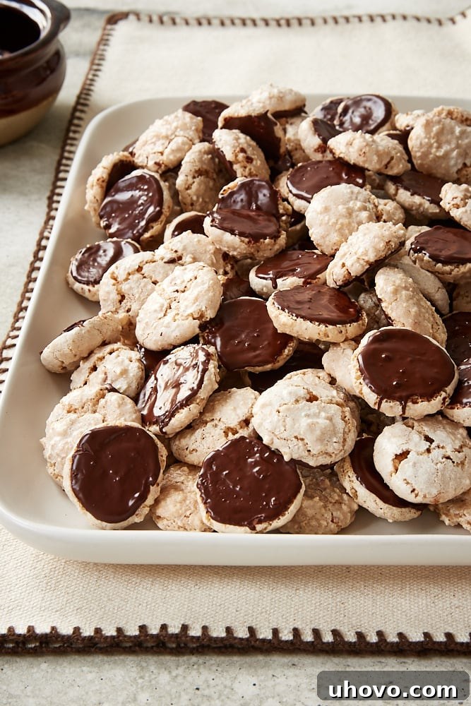 Freshly baked Hazelnut Macaroons neatly arranged on a white serving tray, showcasing their perfect texture and golden hue.