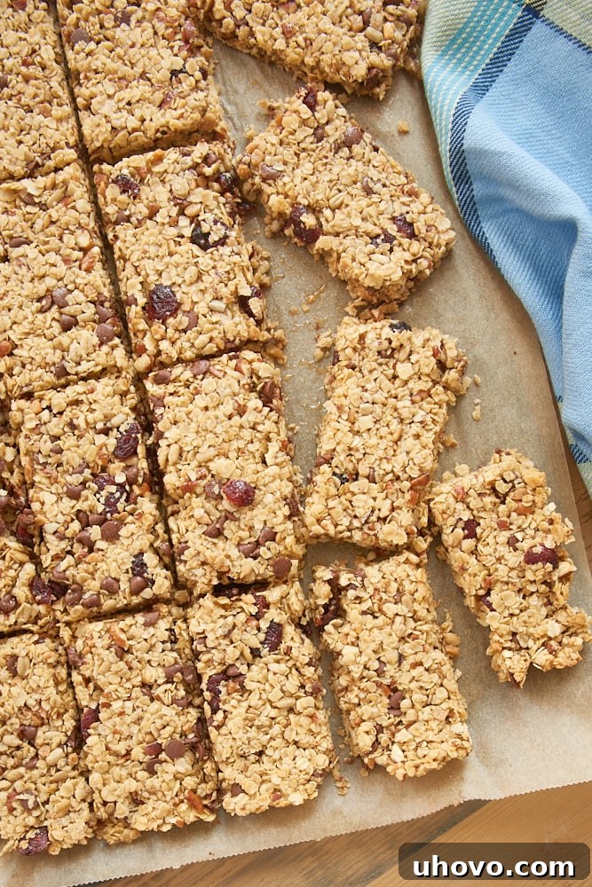 sliced Cranberry Chocolate Chip Pecan Granola Bars on parchment paper
