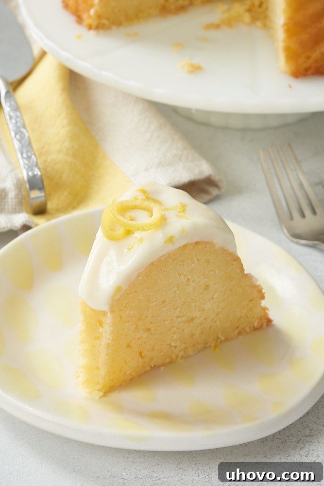 slice of Lemon Bundt Cake on a white and yellow plate