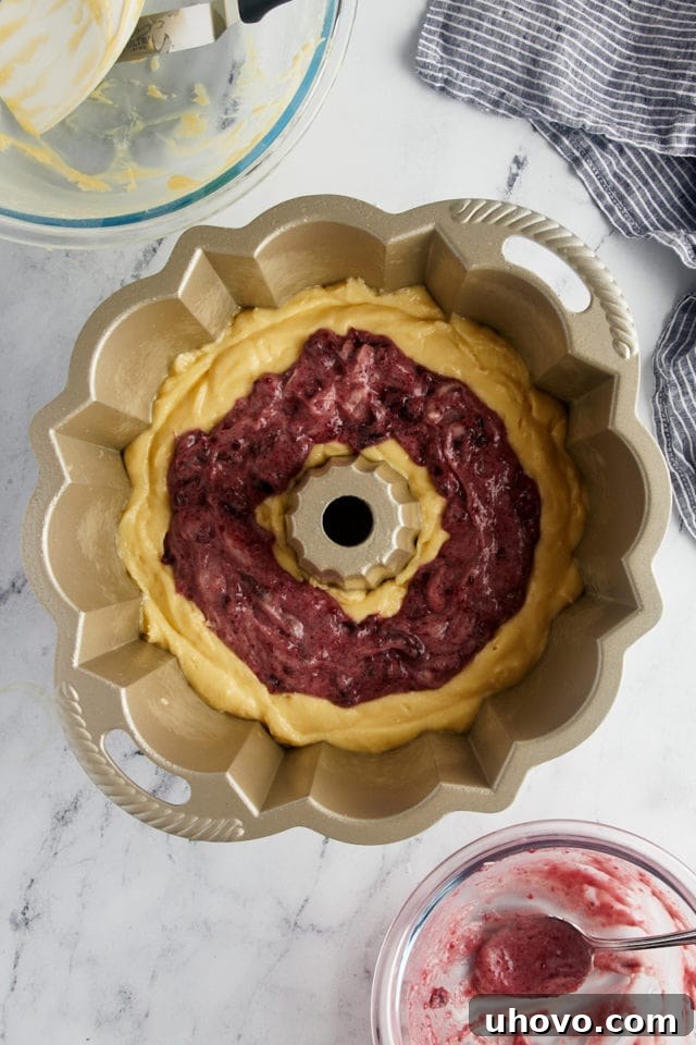 Overhead view of the assembled Black Cherry Sour Cream Coffee Cake, with its vibrant cherry swirl, poised to go into the oven.
