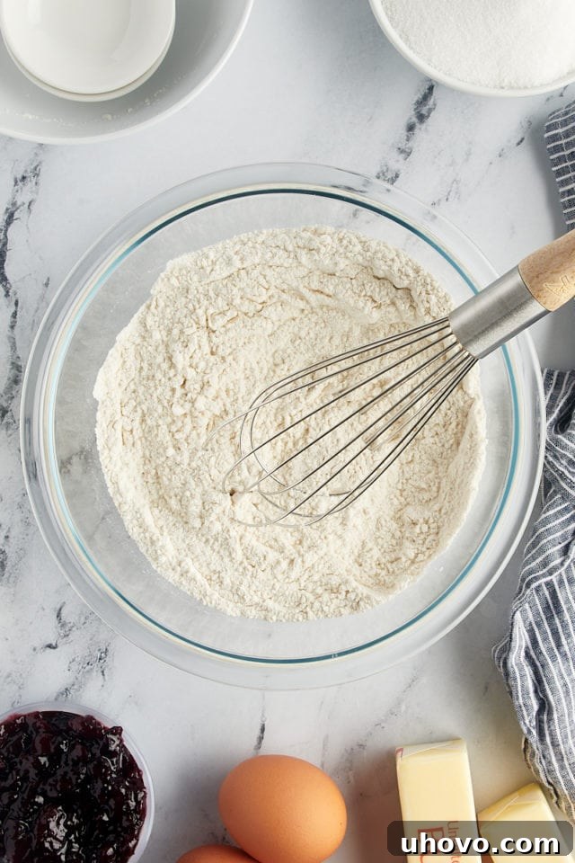 A close-up overhead view of the thoroughly mixed dry ingredients for the Black Cherry Sour Cream Coffee Cake in a glass bowl.
