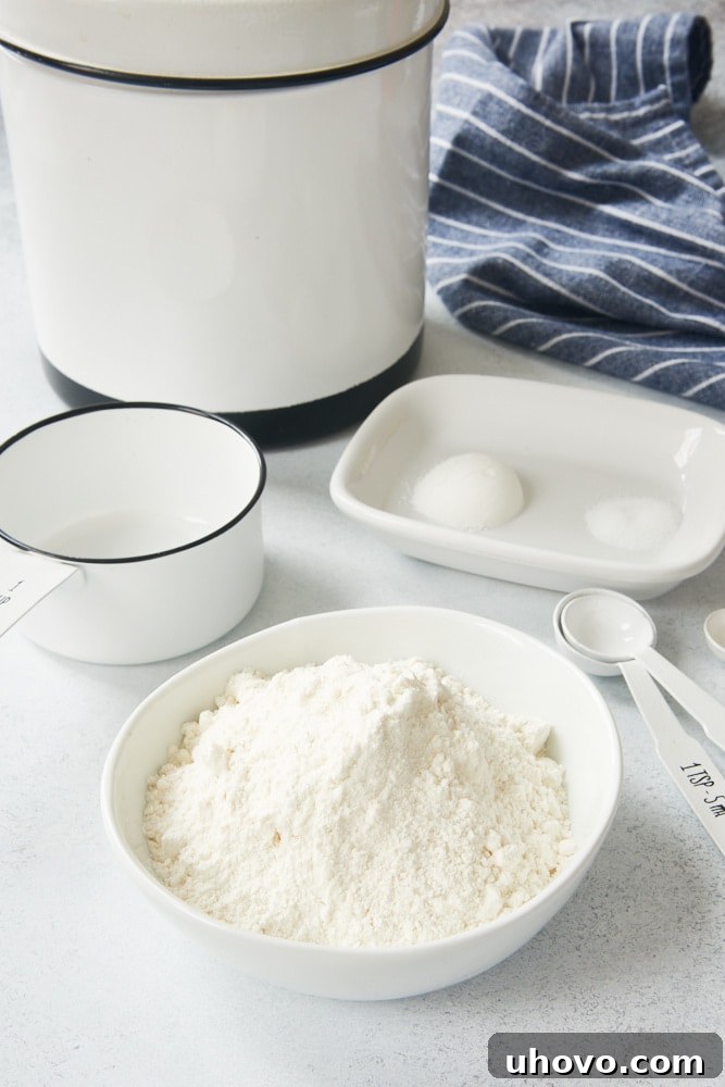 Ingredients laid out for making self-rising flour: flour, baking powder, and salt in measuring spoons.