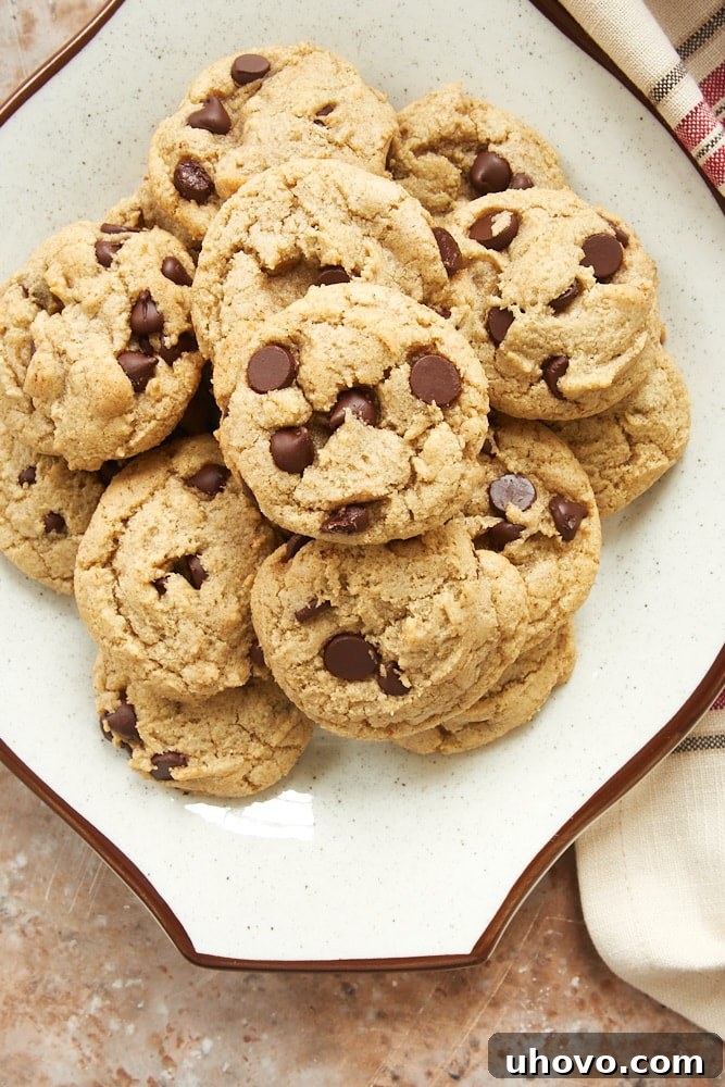 An overhead shot displaying a plate of freshly baked Rye Chocolate Chip Cookies, highlighting their inviting texture and rich chocolate distribution. These warm, golden-brown cookies are ready to be enjoyed.