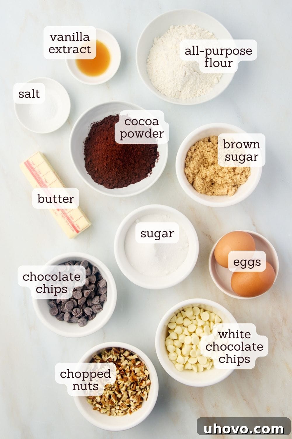 Overhead view of all ingredients for triple chocolate brownies laid out on a kitchen counter