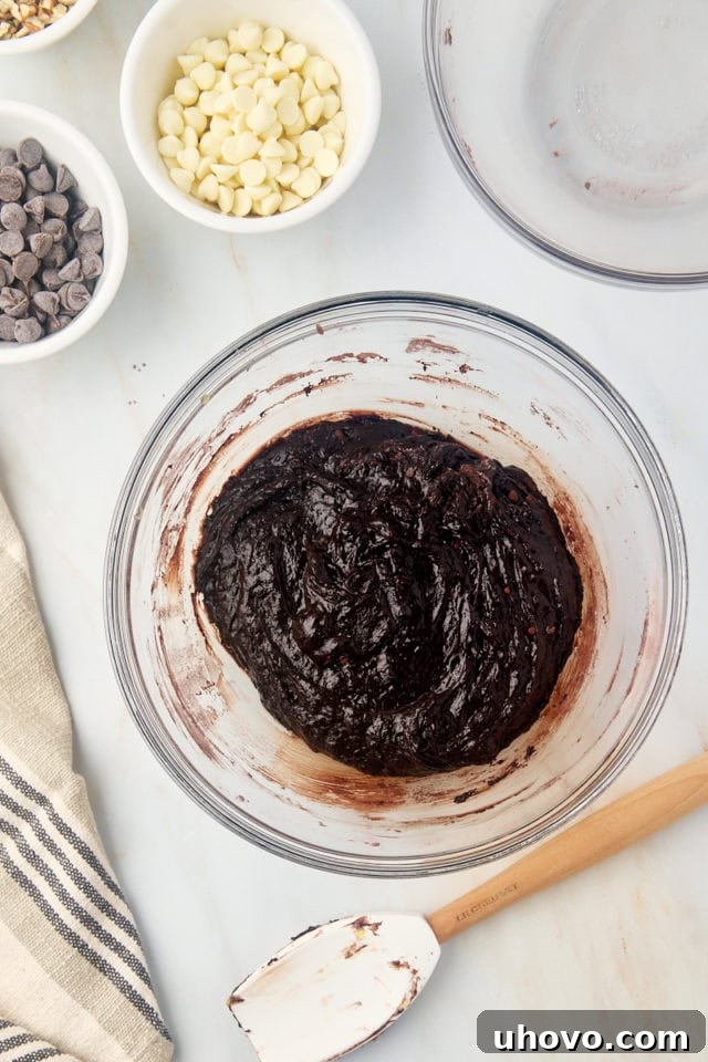Overhead view of brownie batter in a mixing bowl, just combined