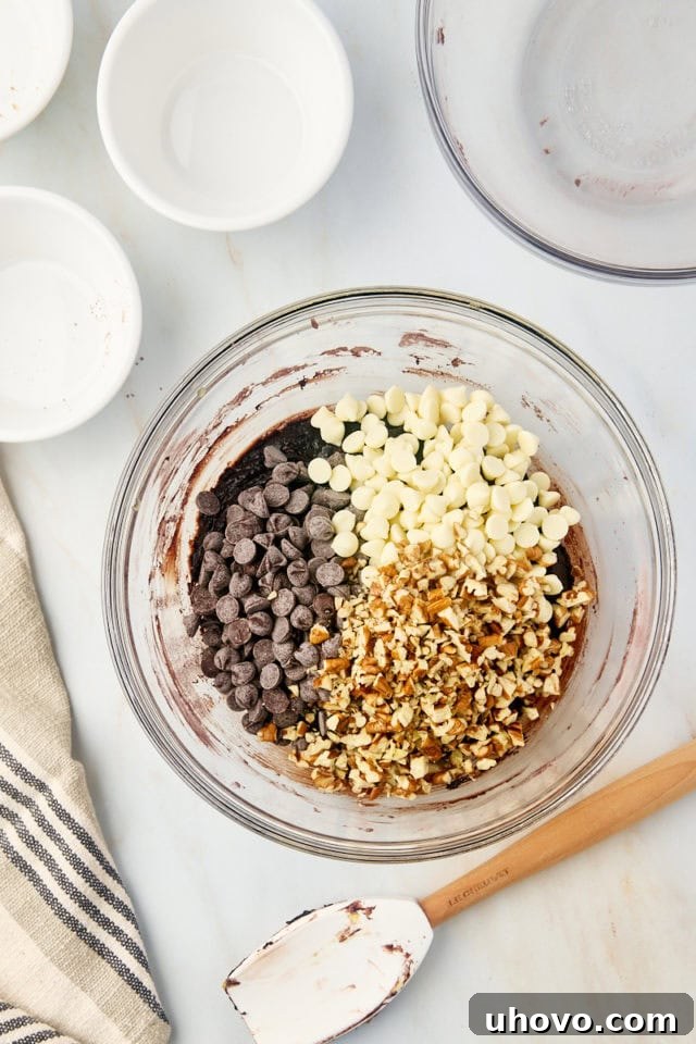 Overhead view of nuts and chocolate chips added to brownie batter