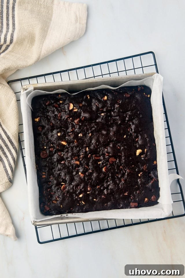 Overhead view of triple chocolate brownie batter spread evenly in a baking pan