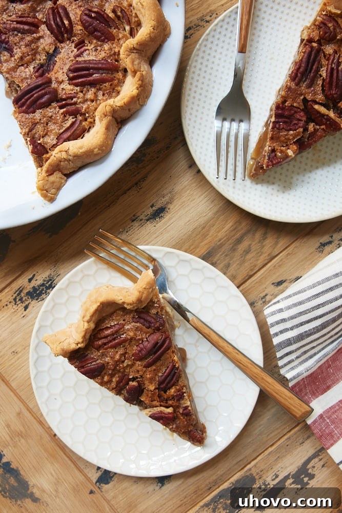 overhead view of slices of Irish Cream Pecan Pie on white and beige plates