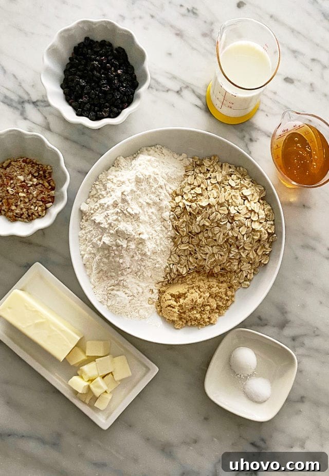 A visual guide: all the essential ingredients for making Currant Oat Scones laid out on a clean surface.