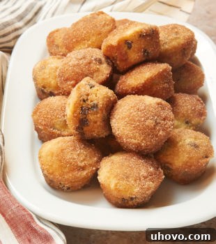 Mini Chocolate Chip Doughnut Muffins piled high on a white tray