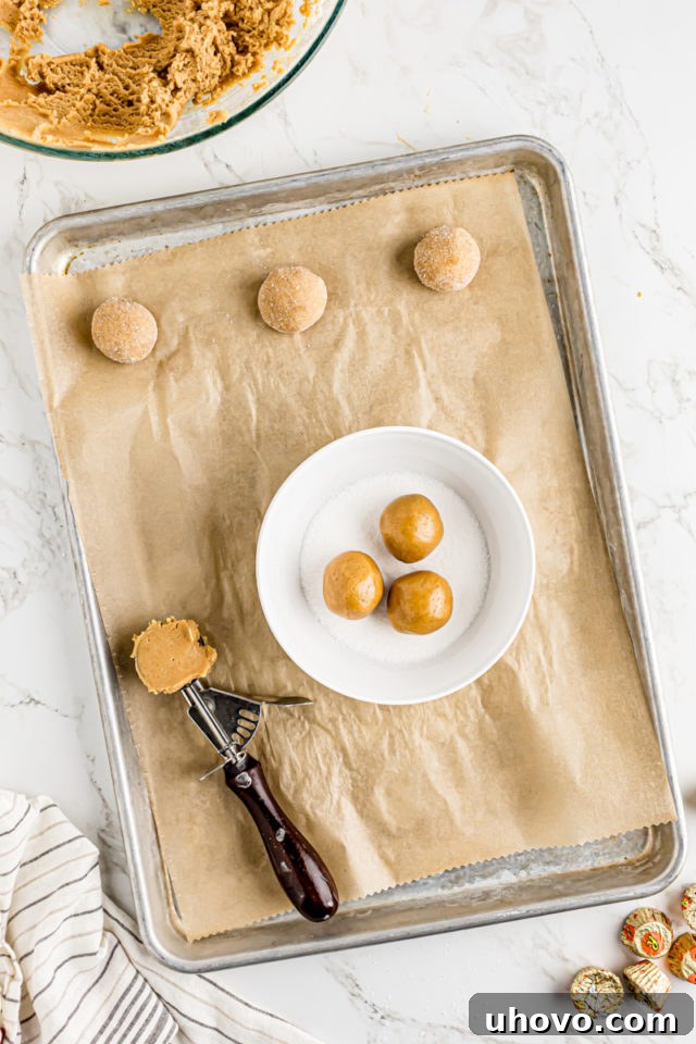 Rolling peanut butter dough balls in sugar
