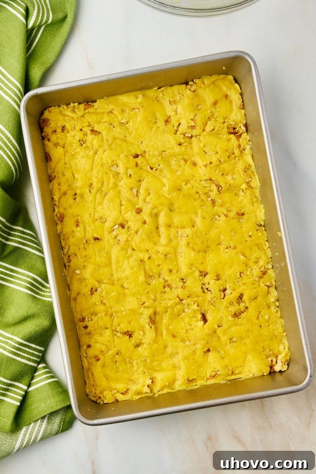 overhead view of chess squares crust mixture spread in a baking pan
