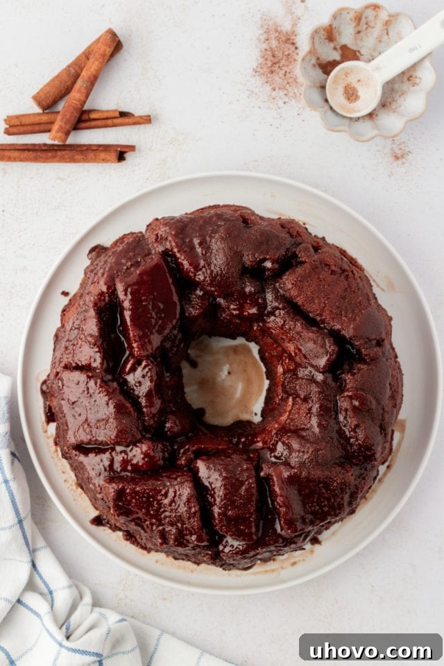 Overhead view of the perfectly inverted chocolate monkey bread on a decorative serving platter, revealing its beautiful, golden-brown, and sticky exterior, ready to be pulled apart.