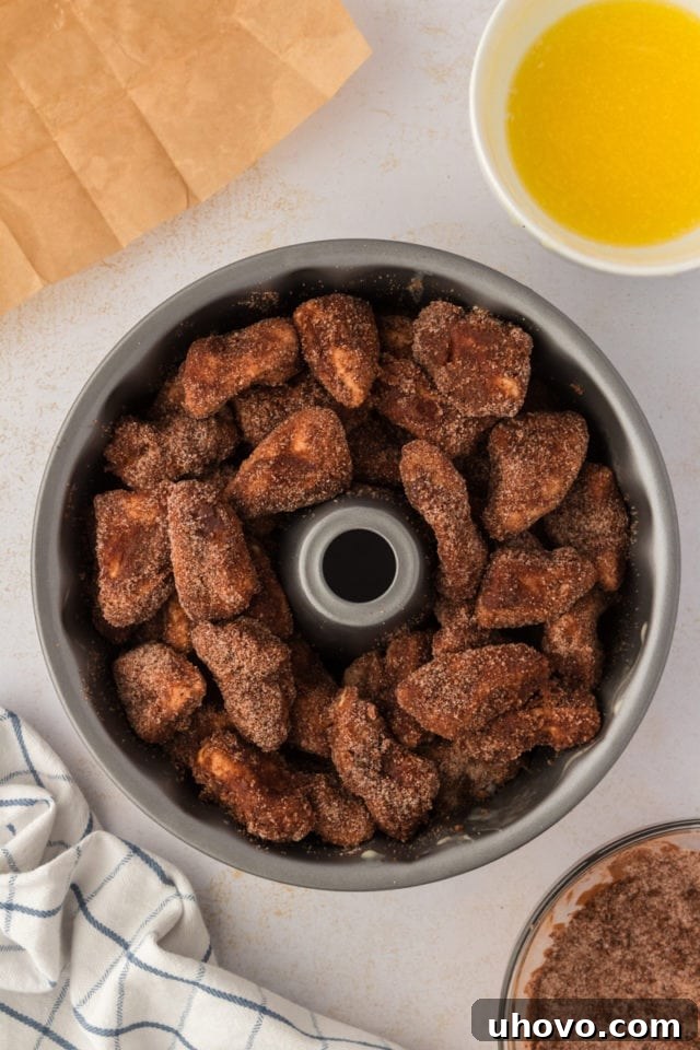 Overhead view of the unbaked chocolate monkey bread, with all the coated biscuit dough pieces neatly arranged within the Bundt pan, ready for the oven.