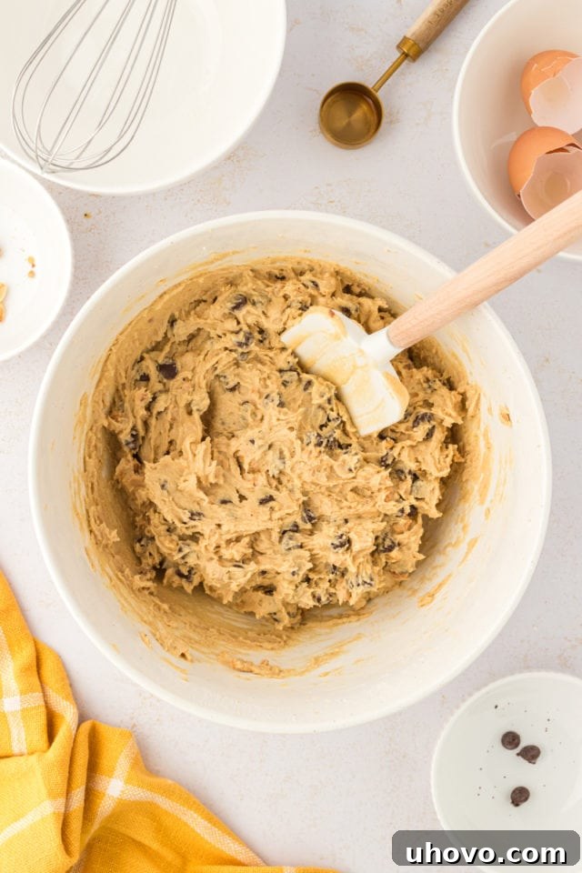 An overhead view of the thoroughly mixed dough for toffee squares, rich with nuts and chocolate chips, ready for the next step.