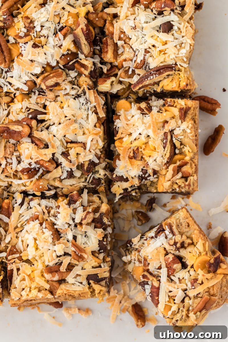 An overhead view of perfectly sliced toffee squares arranged on parchment paper, showcasing their even cuts and rich, inviting layers.