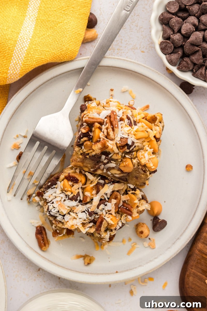 An overhead view of two perfect toffee squares presented on a white plate with a fork, ready to be enjoyed.