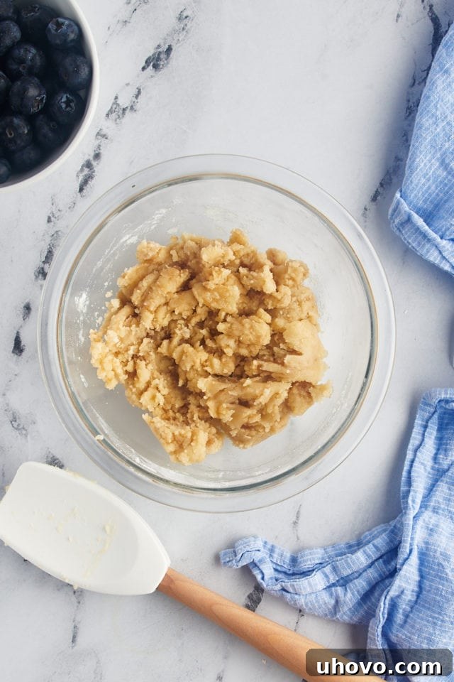 Overhead view of crumb mixture in glass bowl