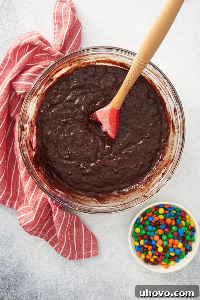 overhead view of brownie batter in a glass mixing bowl