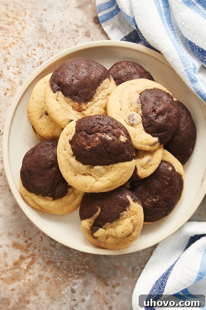 Close-up overhead shot of Chocolate Peanut Butter Swirl Cookies arranged neatly on a beige plate, highlighting their soft texture and appealing marble effect.