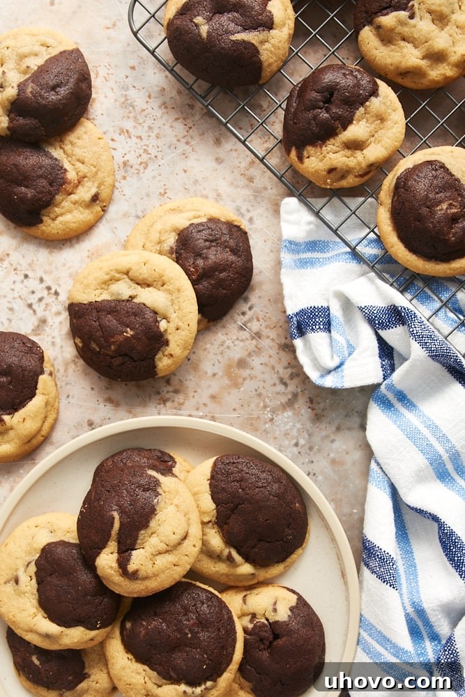 A collection of Chocolate Peanut Butter Swirl Cookies displayed on a wire rack, a beige plate, and a light brown surface, showing various angles of their delicious patterns.