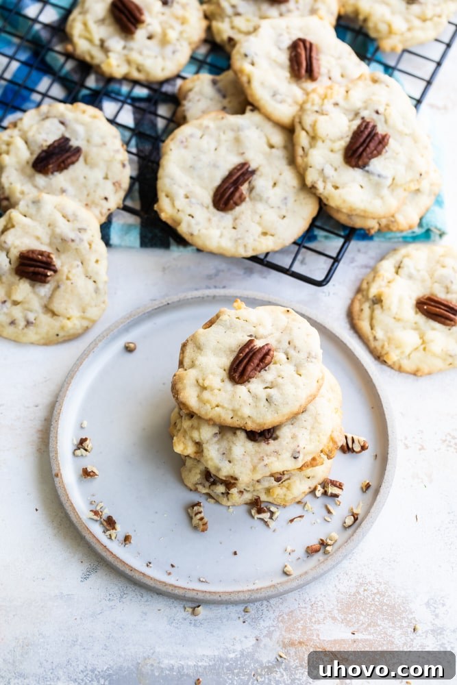 A mix of Potato Chip Cookies on a white plate and some cooling on a wire rack, showcasing their varied textures and inviting golden color.